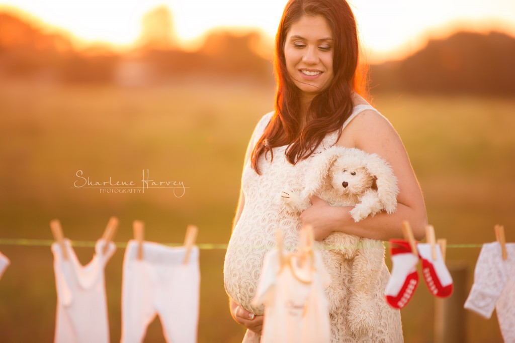 Glow Pregnant Mother poses in front of baby clothes - Mornington Peninsula Pregnancy Photographer