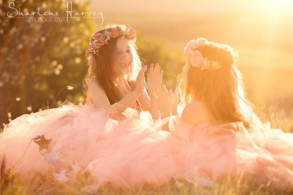 Beautiful girls playing patticake in the sunlight