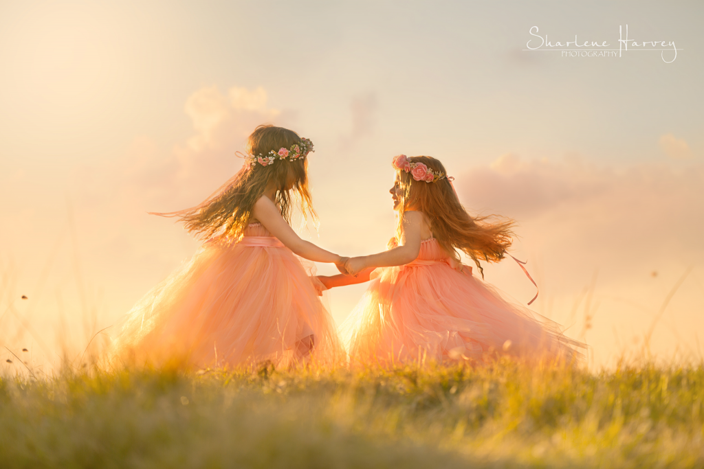 Two girls skipping together on a hill