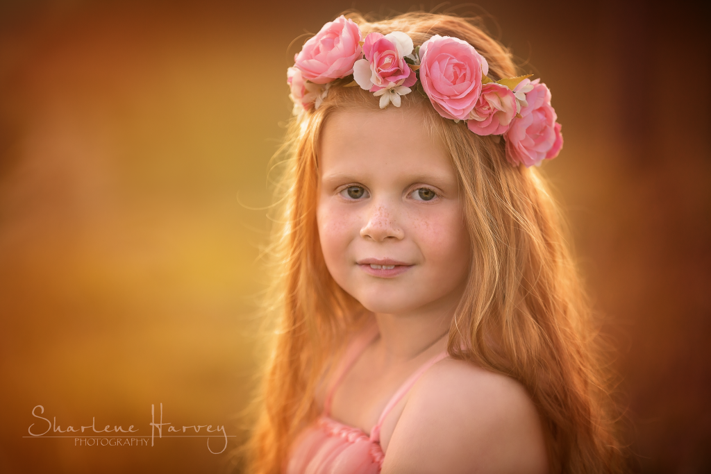 Gorgeous redheaded girl in backlit sunset
