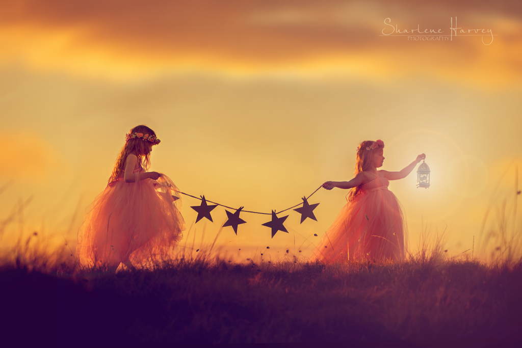 Girls carrying stars during dusk sunset